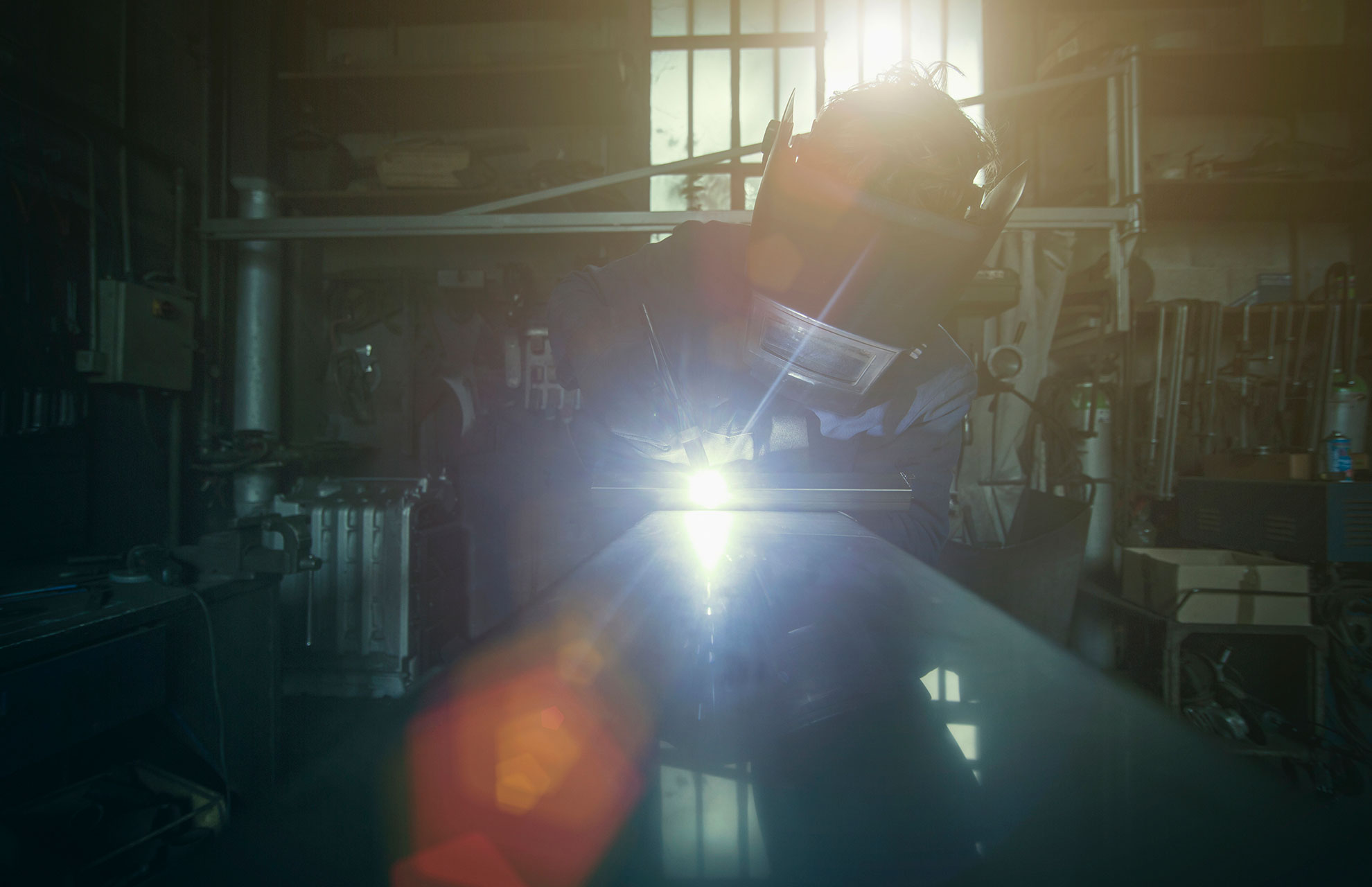 welder-soldering-iron-in-workshop-UNJ7ZDQ